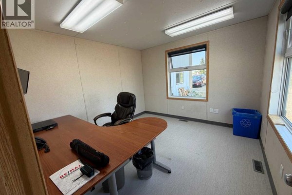 Office with L-shaped desk, chair, window, and blue recycling bin. - 11 & 13, 27123 Highway 597, Rural Lacombe County