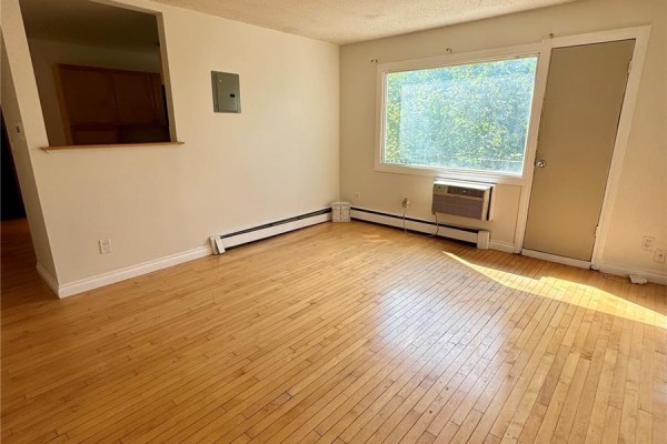 Kitchen with light wood cabinets, granite countertops, black appliances, and a window. - 11 2320 13th Avenue, Regina