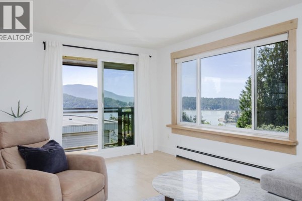 View from the rooftop showing distant mountains and calm blue water. - 11 694 School Road, Gibsons
