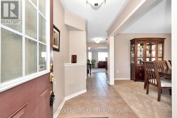Powder room featuring a toilet, towel rack, and decorative wall mirror - 11 Bonavista Drive, Brampton