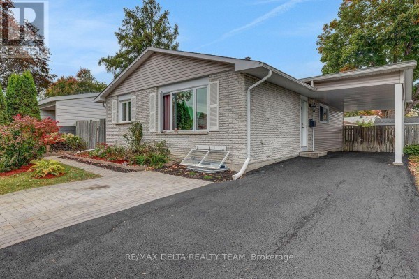 A light brick bungalow with a carport and landscaping on a tree-lined street. - 11 Courtney Road, Ottawa