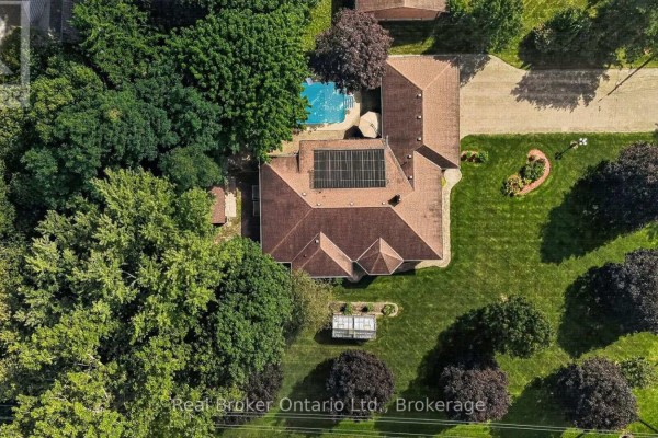 Direct overhead view of a ranch home with a pool, solar panels, and landscaped gardens. - 11 Elisabeth Street, East Zorra Tavistock