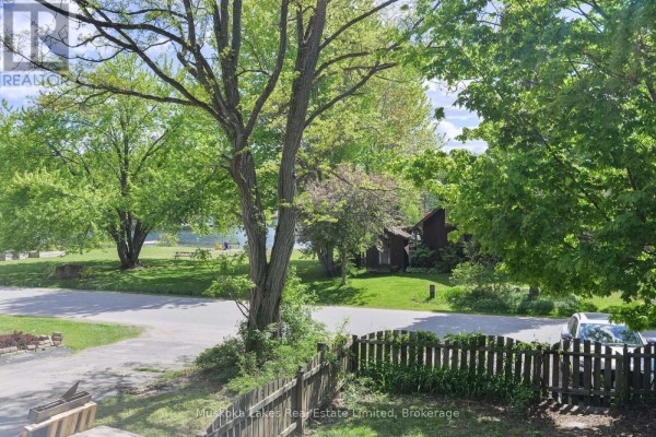 View of the lake and surrounding green space from the property. - 11 Harris Street, Muskoka Lakes
