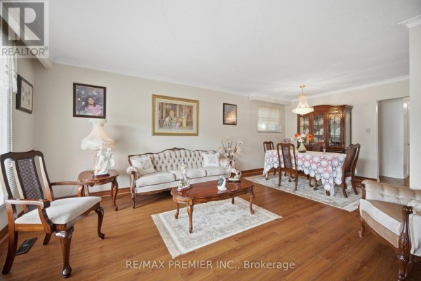 Bedroom with a twin bed, wooden armoire, and window with white curtains. - 11 Kinnie Court, Toronto