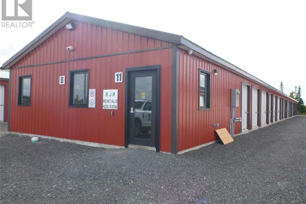 Exterior view of commercial storage facility with red buildings and gravel lot - 11 Omahony Drive, Clarenville