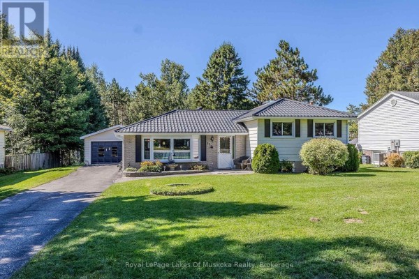 Full front exterior view of a residential home with a paved driveway and attached garage. - 11 Pine Street, Bracebridge
