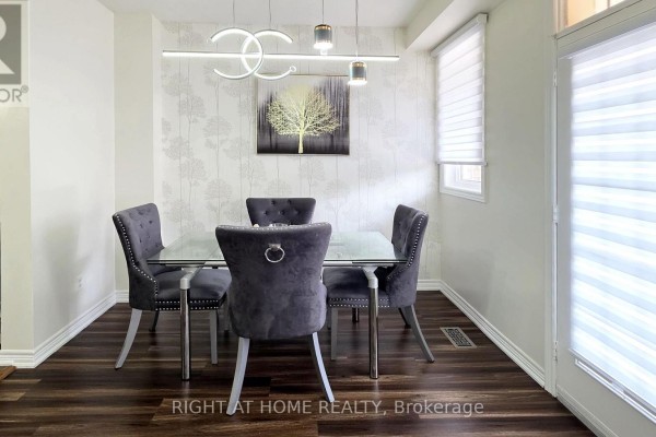 Dining area with a glass-top table, upholstered chairs, and patterned wallpaper. - 11 Pottle Lane, Ajax