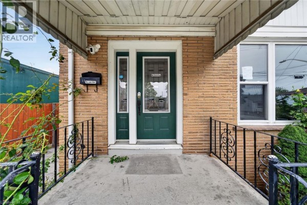 Front door entrance with sidelight windows, a mailbox, and brick facade. - 11 Selkirk Avenue, Hamilton