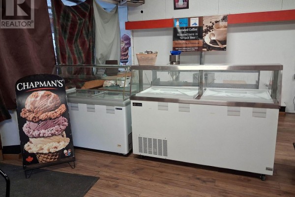 Two glass-top display freezers and an ice cream advertising sign. - 11 Simcoe Plaza, Terrace Bay