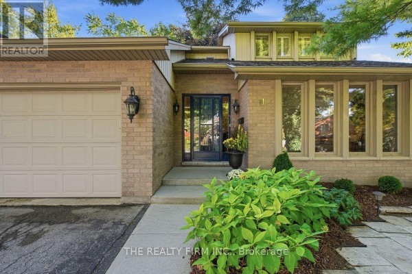 Close-up of the front entrance with a glass door, brick facade, and landscaping. - 11 Somerset Crescent, London South