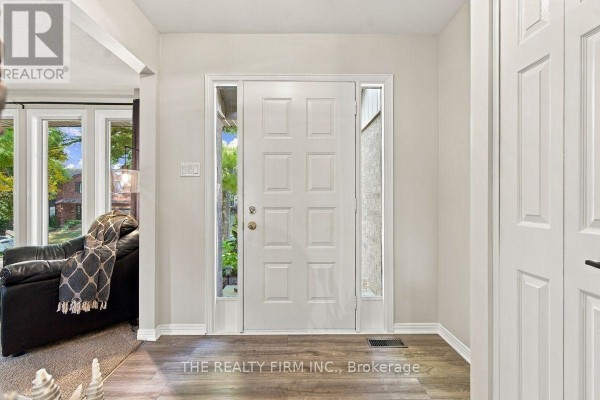 Interior view of a white front door with sidelights and hardwood flooring. - 11 Somerset Crescent, London South