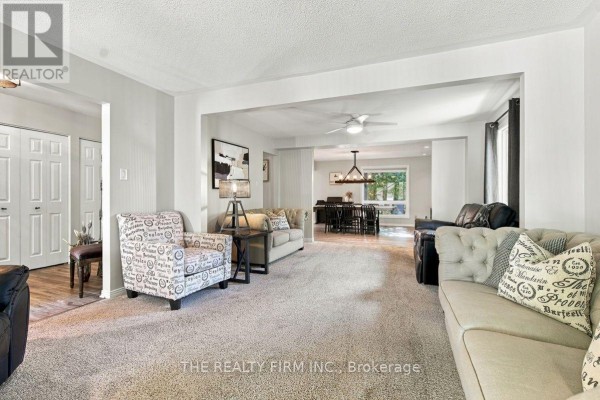 View of a living room connected to a dining area with a large chandelier. - 11 Somerset Crescent, London South