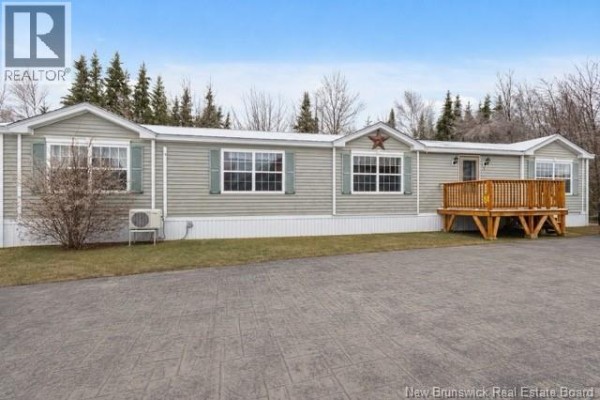 Side exterior view of a light gray modular home with a white car parked in the driveway. - 11 Wendy Crescent, Rusagonis