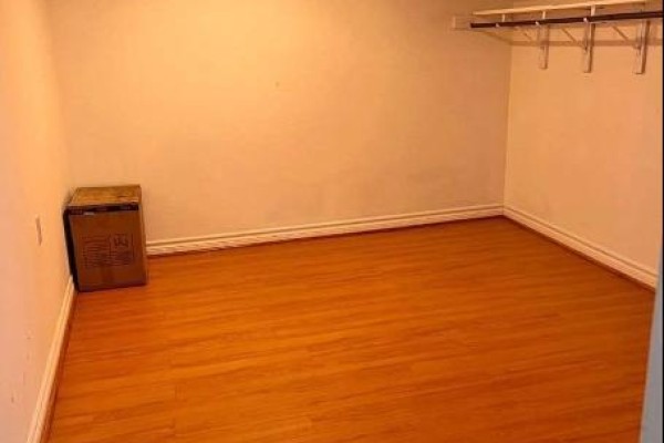 Unfurnished room with laminate flooring and wall-mounted shelves. - 11 Zeng Cheng Drive, Markham