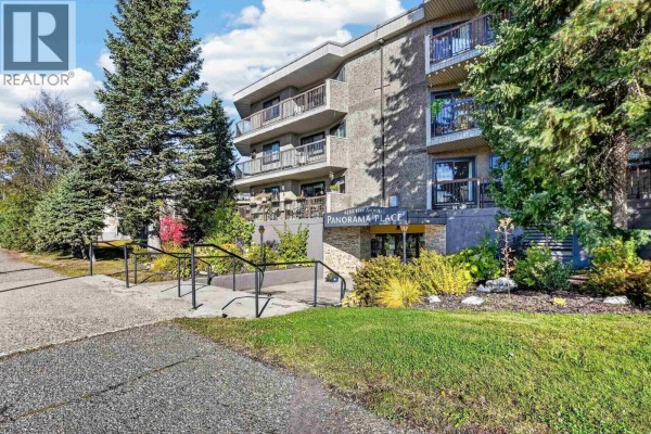 View of the Panorama Place apartment building entrance with landscaping. - 110 4288 15th Avenue, Prince George