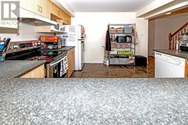 Kitchen with stainless steel oven, mixer, and storage rack - 110 Chartley Private Ottawa