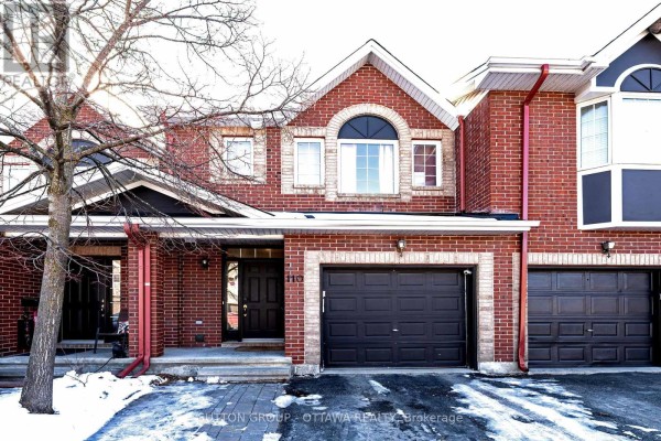 Brick townhouse with attached double garage, covered entryway, and arched window - 110 Chartley Private Ottawa