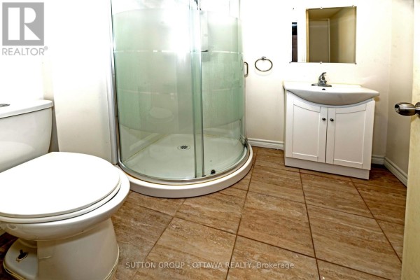 Corner shower, vanity, and toilet in bathroom - 110 Chartley Private Ottawa