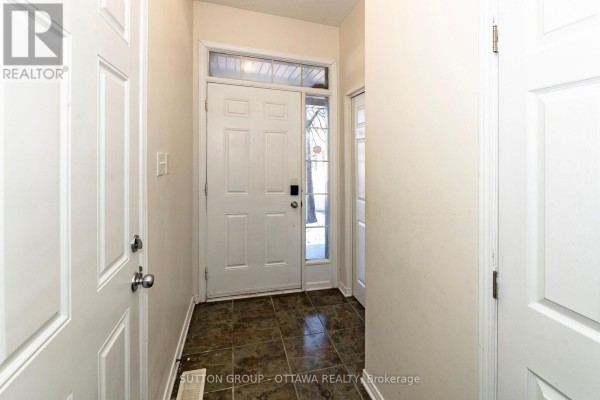 Entryway with front door, window, and tiled floor - 110 Chartley Private Ottawa