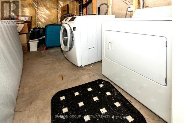 Washer, dryer, and storage items in a basement laundry area - 110 Chartley Private Ottawa