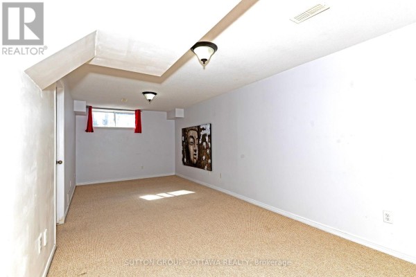 Finished basement with carpet, Buddha art, and red curtains - 110 Chartley Private Ottawa