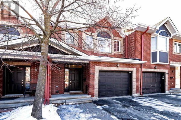Townhouse with brick exterior and two-car garage - 110 Chartley Private Ottawa