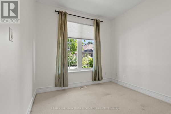 Bedroom with neutral carpet, large window, and green curtains. - 110 Heathercrest Private, Ottawa