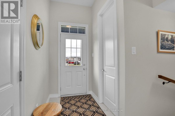 Bright foyer with front door and window, tiled flooring - 110 Main Halyard Lane, Ottawa