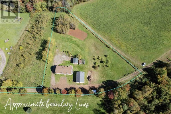 Aerial view showing property boundaries of a barn and garage complex. - 1100 Highway 6, Warren