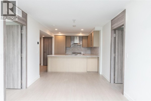 Open concept living area and kitchen with light wood cabinets and stone backsplash. - 1101 8800 Hazelbridge Way, Richmond