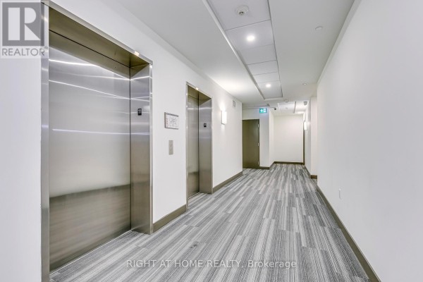 Building hallway with double elevators and modern carpeting. - 1102 - 100 Garment Street, Kitchener