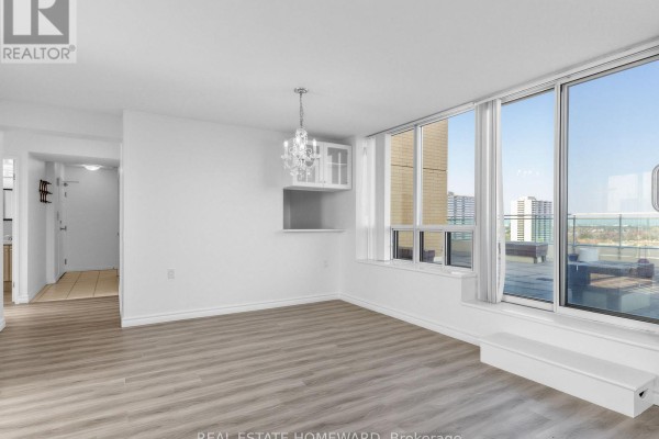 Well-lit room with chandelier, large windows, and view of outdoor space - 1102 - 2800 Warden Avenue, Toronto