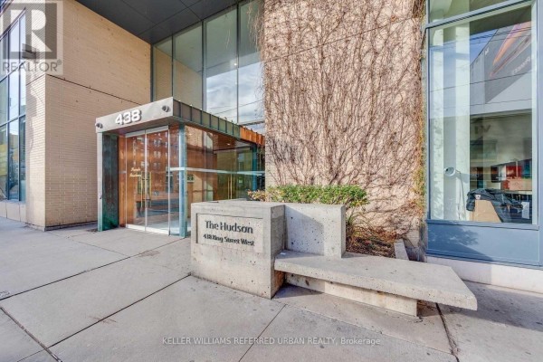 Entrance to The Hudson condo building at 438 King Street West with concrete seating and signage. - 1102 - 438 King Street W, Toronto