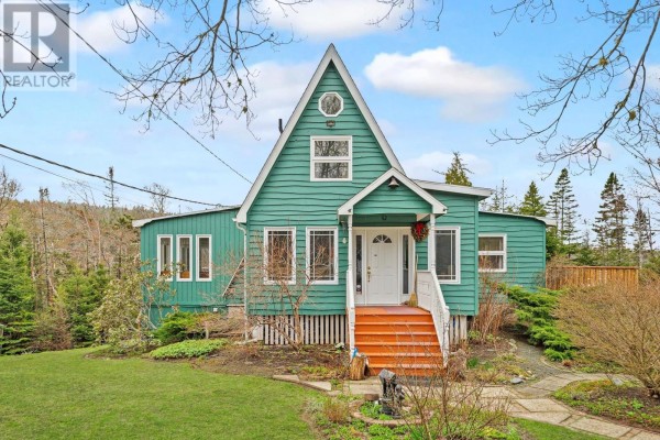 Front exterior of a teal house with a white door, orange steps, and multiple windows. - 11028 Highway 7, Lake Charlotte