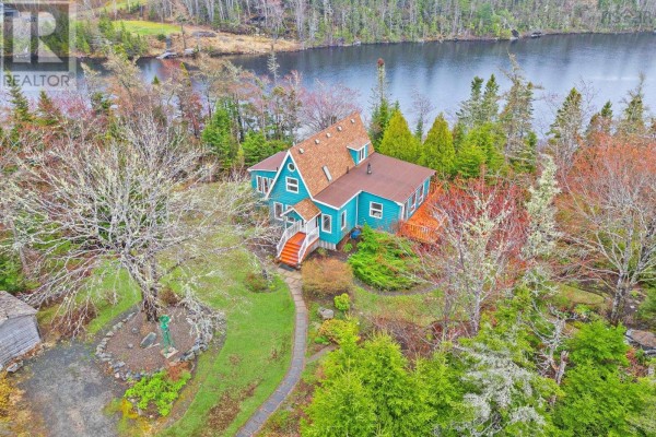 Overhead view of a teal house with decks and a unique A-frame roof overlooking a lake. - 11028 Highway 7, Lake Charlotte