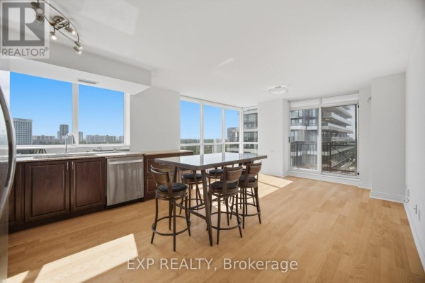 Balcony with railing overlooking surrounding apartment buildings, trees, and a distant city skyline. - 1103 - 1103 Leslie Street, Toronto