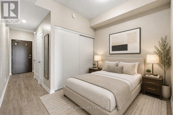 The main entrance to the 15 Queen Street South apartment building features glass doors and signage. - 1103 - 15 Queen Street S, Hamilton