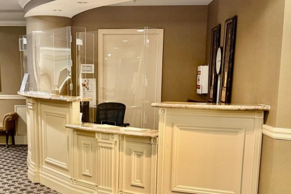 Reception desk with clear protective screens and marble countertop. - 1103 - 350 Princess Royal Drive, Mississauga