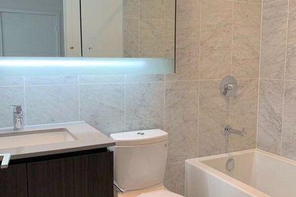 A clean bathroom with a marble tiled shower, modern vanity, and soaking tub. - 1107 - 115 Mcmahon Drive, Toronto