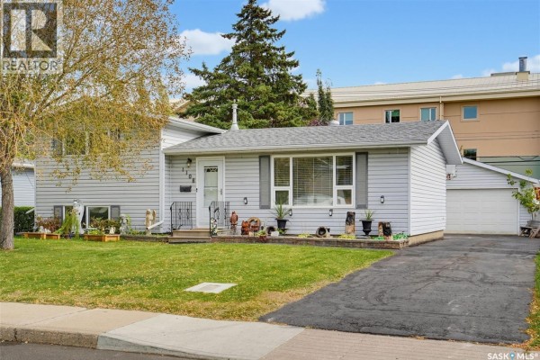 Exterior view of the house with a driveway and attached garage. - 1108 Tiffin Crescent, Saskatoon