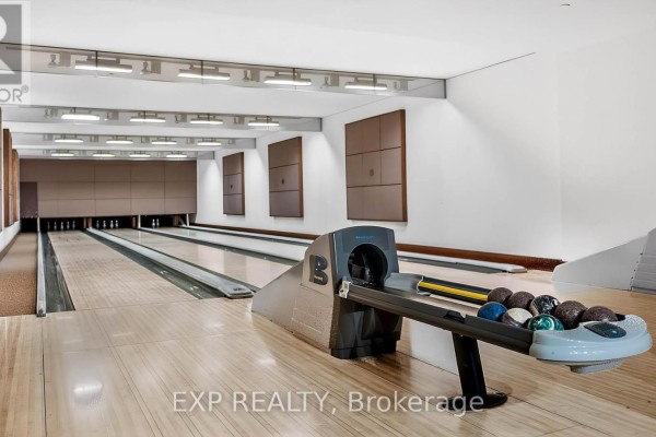 An indoor bowling alley with multiple lanes and a ball return system. - 1109 - 5 Northtown Way, Toronto