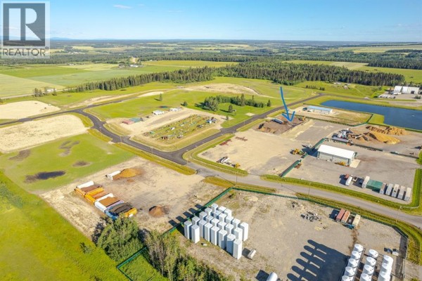 Aerial view of an industrial park with various storage tanks, buildings, and construction. - 111, 32532 Range Road 42, Rural Mountain View County