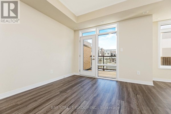 Bright room with large windows and door leading to outdoor space - 111 - 1573 Rose Way, Milton