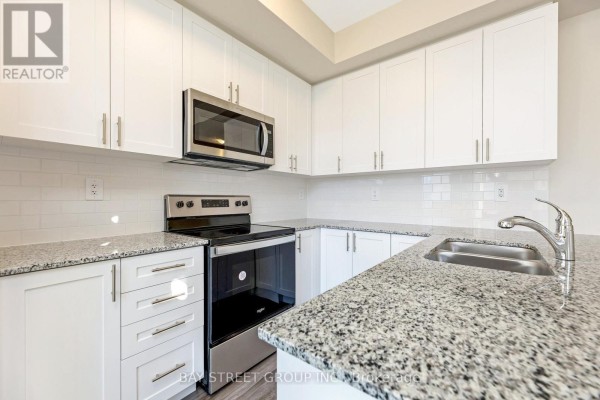 Close-up of kitchen featuring granite countertops and modern fixtures - 111 - 1573 Rose Way, Milton