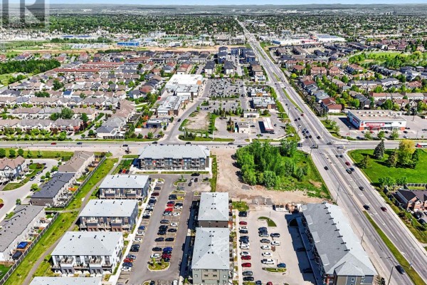 Aerial view of a suburban street with apartment buildings, townhouses, and commercial properties. - 111 - 2370 Tenth Line Road, Ottawa