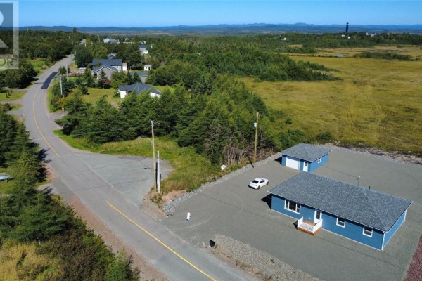 Aerial view of a blue sided house, detached garage, and a white car on gravel. - 111-113 Branch Hill Road, Winterland