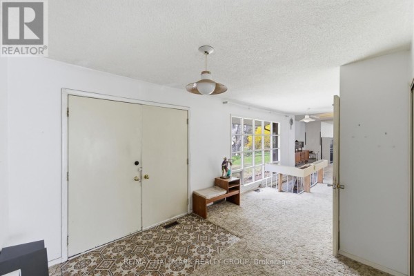 Interior entryway with double white doors, patterned carpet, and a window overlooking the yard. - 111 Elmgrove Road, Drummond/north Elmsley