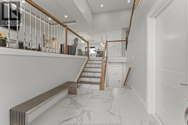 Interior staircase with marble steps, leading to an open space below. - 111 Lambert Street, Amherstburg
