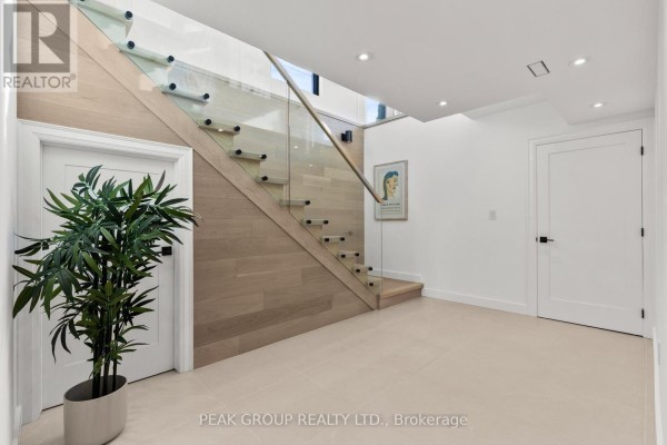 Modern staircase with glass railing and wood treads - 111 Millpond Road Niagara On The Lake