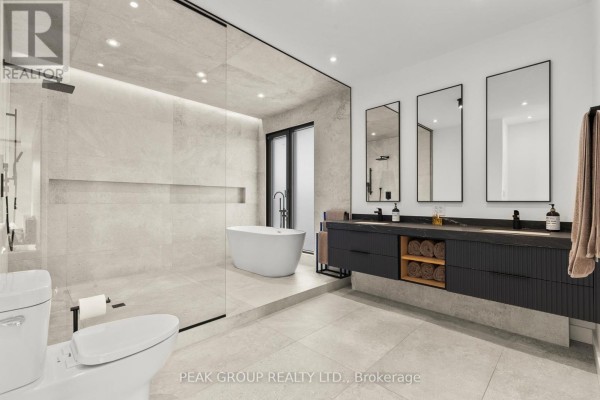 Modern kitchen with island, marble countertops, and wood cabinets - 111 Millpond Road Niagara On The Lake